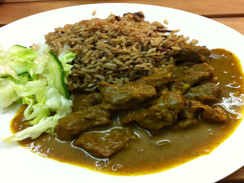 Curry goat with rice and peas