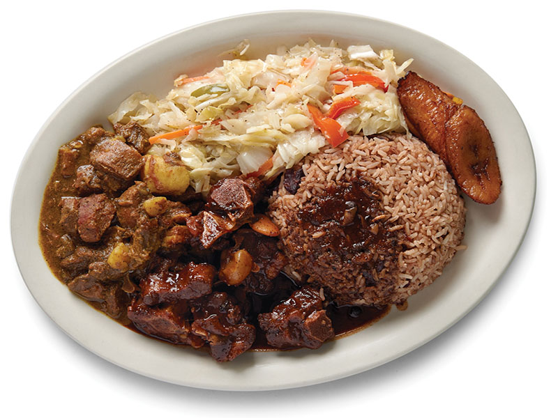 Curry goat with rice and peas, side salid with plantin